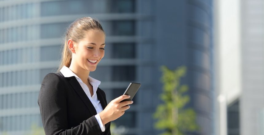 Executive,Working,With,A,Mobile,Phone,In,The,Street,With