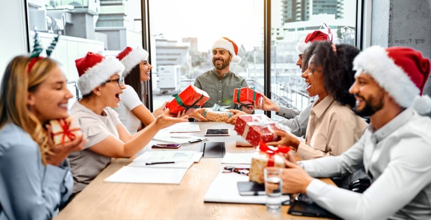 Colleagues,At,Work,Give,Each,Other,New,Year's,Gifts,While