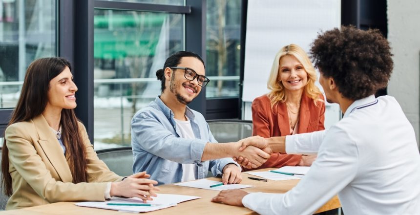 A,Group,Of,Job,Seekers,Shaking,Hands,At,A,Table