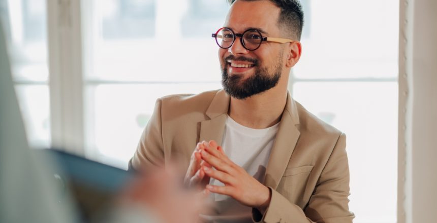 Businessman,Listening,Attentively,And,Smiling,During,A,Meeting,With,A