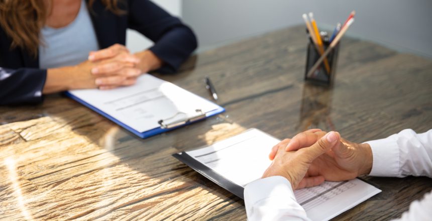 Close-up,Of,Businessman,Sitting,With,His,Colleague,At,Workplace
